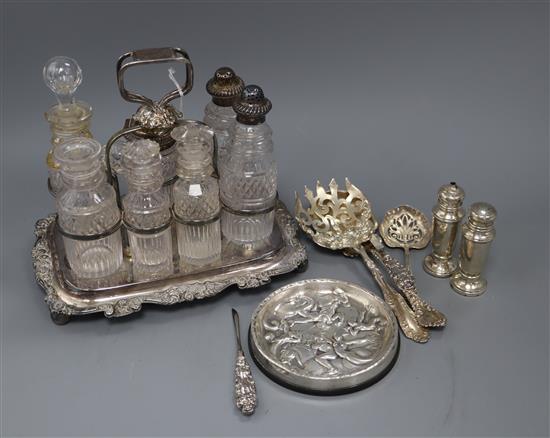 Two American sterling servers, a Swedish white metal mounted plaque, silver pepperettes and a plated cruet stand with bottles.